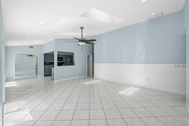 2749 Digby Rd SE, Palm Bay, FL 32909 - spare room featuring a ceiling fan, a wainscoted wall, a skylight, and recessed lighting