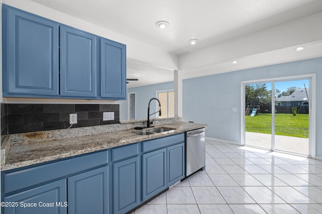 2749 Digby Rd SE, Palm Bay, FL 32909 - kitchen with dishwasher, blue cabinets, light tile patterned flooring, light stone countertops, and recessed lighting