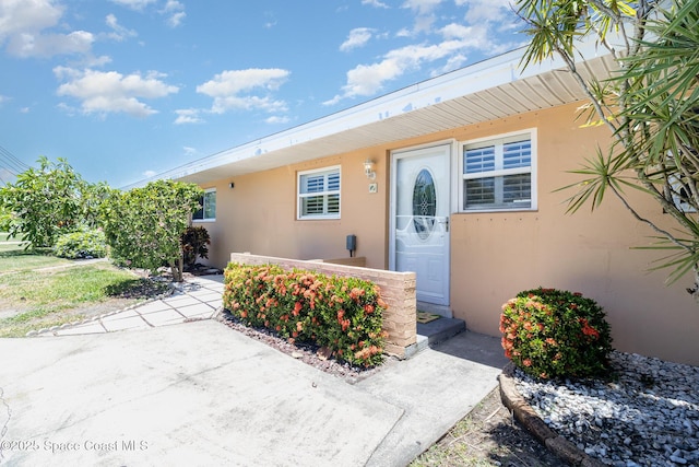 714 Catalina Rd Unit 2, Cocoa Beach, FL 32931 - doorway to property with stucco siding