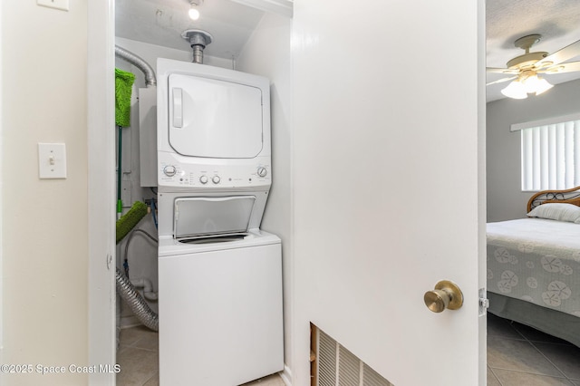 714 Catalina Rd Unit 2, Cocoa Beach, FL 32931 - washroom featuring stacked washer / drying machine, tile patterned floors, and ceiling fan