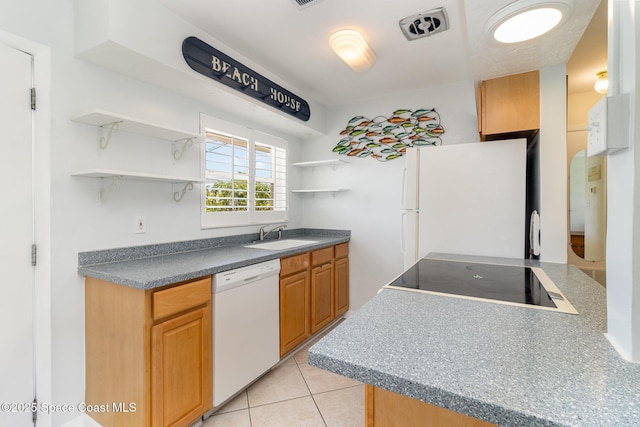 714 Catalina Rd Unit 2, Cocoa Beach, FL 32931 - kitchen with white appliances, open shelves, light tile patterned floors, and dark countertops