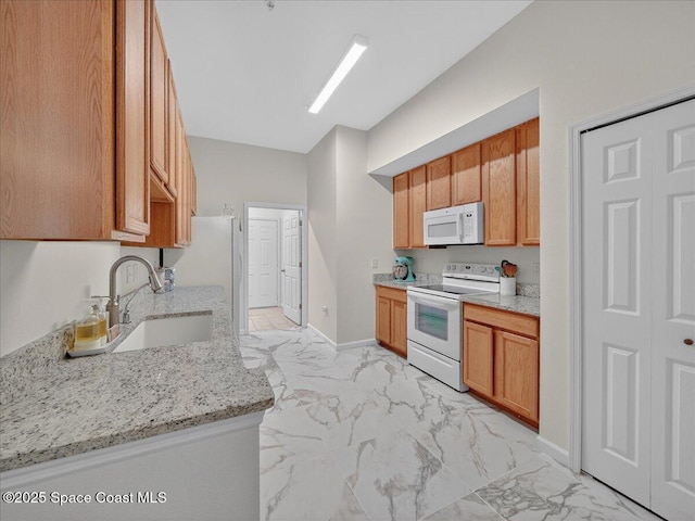 4086 Meander Pl Unit 104, Rockledge, FL 32955 - kitchen featuring white appliances, light marble finish floors, light stone counters, and brown cabinetry