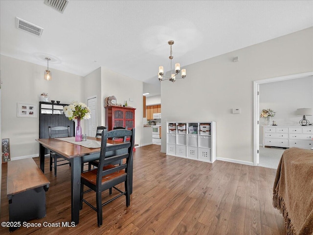4086 Meander Pl Unit 104, Rockledge, FL 32955 - dining room featuring a chandelier and wood finished floors