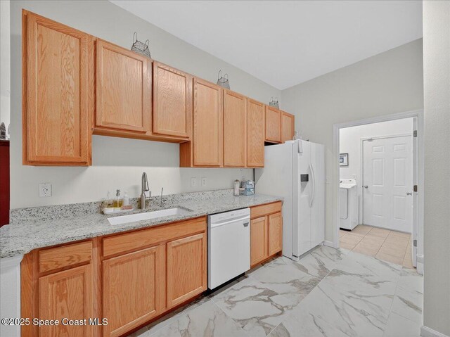 4086 Meander Pl Unit 104, Rockledge, FL 32955 - kitchen with white appliances, washer / clothes dryer, light marble finish flooring, light stone countertops, and light brown cabinets