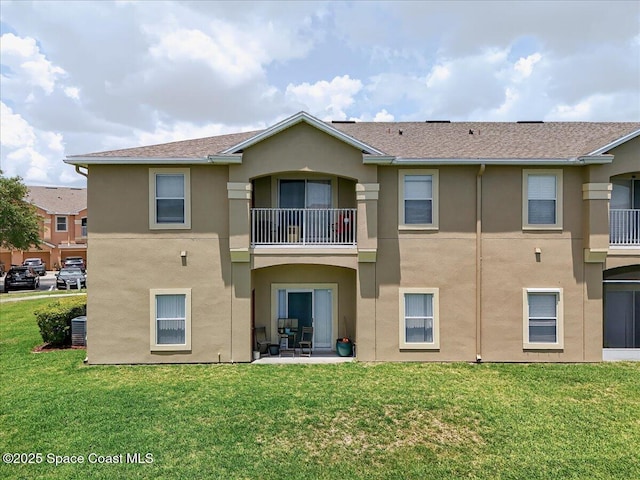 4086 Meander Pl Unit 104, Rockledge, FL 32955 - rear view of property featuring stucco siding, a balcony, and a yard