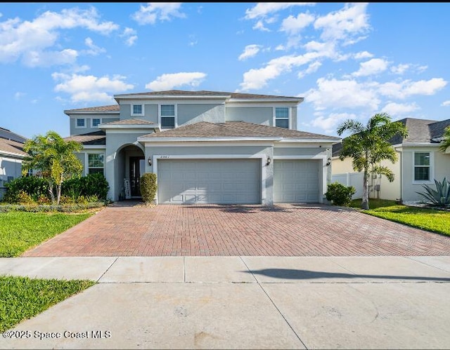 2061 Rush Bay Way, Orlando, FL 32824 - view of front of property featuring decorative driveway, stucco siding, and an attached garage