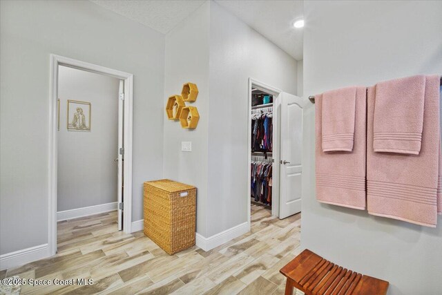 4692 Shannock Ave, Merritt Island, FL 32953 - bathroom with wood finished floors, a walk in closet, and recessed lighting