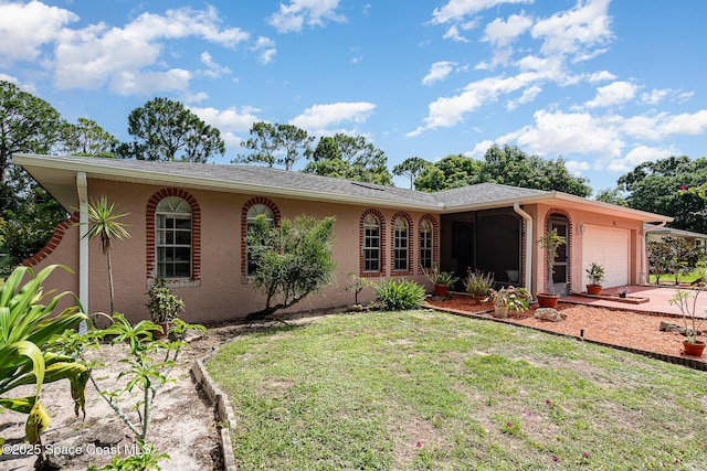 755 Haftez St NE, Palm Bay, FL 32907 - ranch-style house with a garage, stucco siding, a front lawn, and driveway
