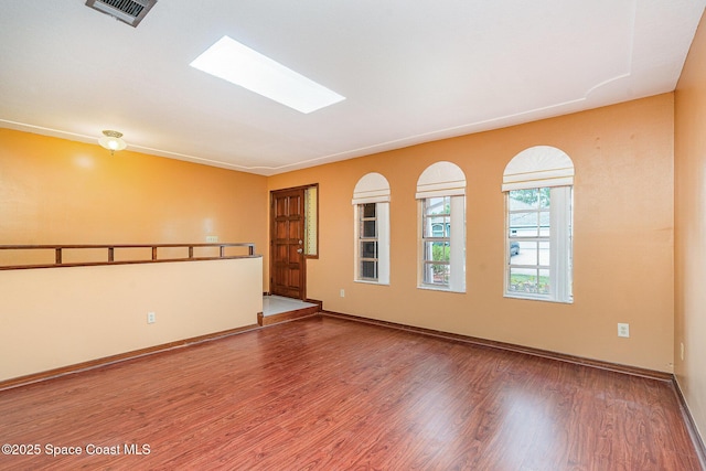 755 Haftez St NE, Palm Bay, FL 32907 - spare room featuring wood finished floors and a skylight
