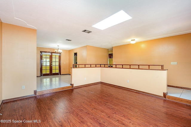 755 Haftez St NE, Palm Bay, FL 32907 - empty room with wood finished floors, a chandelier, and french doors