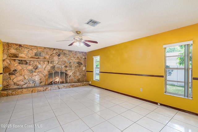 755 Haftez St NE, Palm Bay, FL 32907 - unfurnished living room with a ceiling fan, a fireplace, and light tile patterned floors