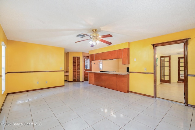 755 Haftez St NE, Palm Bay, FL 32907 - kitchen featuring a peninsula, a ceiling fan, light tile patterned flooring, and light countertops