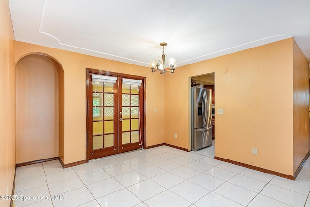 755 Haftez St NE, Palm Bay, FL 32907 - unfurnished room featuring french doors, arched walkways, and a chandelier
