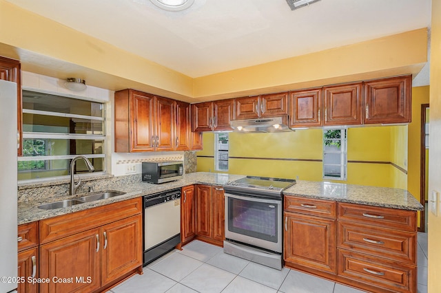 755 Haftez St NE, Palm Bay, FL 32907 - kitchen featuring stainless steel appliances, under cabinet range hood, light tile patterned flooring, and light stone counters