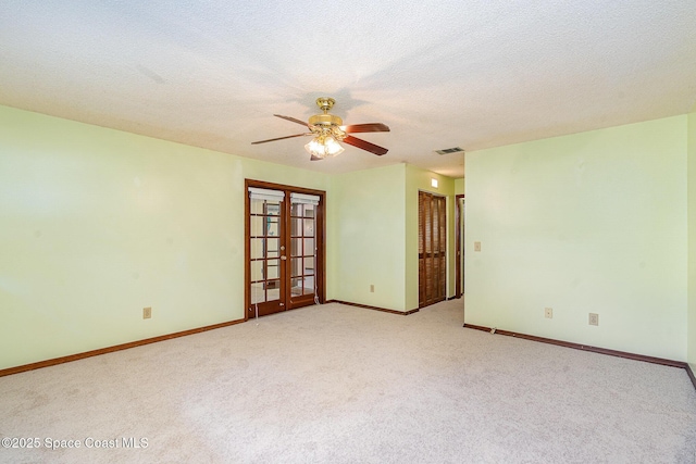 755 Haftez St NE, Palm Bay, FL 32907 - unfurnished room with light carpet, a ceiling fan, french doors, and a textured ceiling