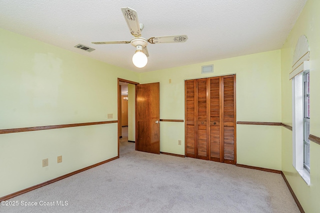 755 Haftez St NE, Palm Bay, FL 32907 - unfurnished bedroom with carpet, a closet, and a ceiling fan