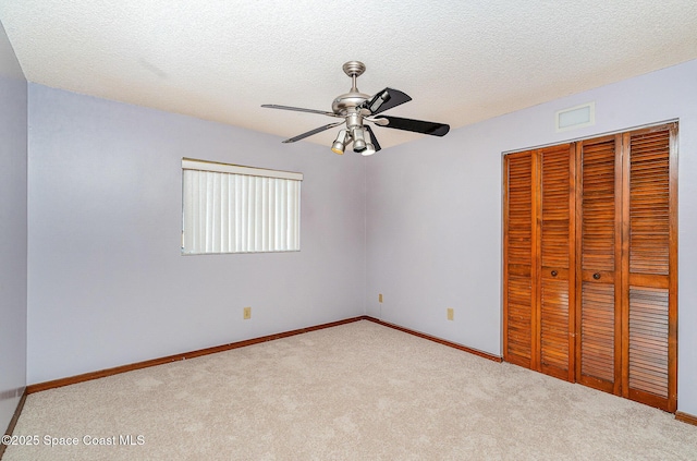 755 Haftez St NE, Palm Bay, FL 32907 - unfurnished bedroom with a closet, carpet floors, a textured ceiling, and a ceiling fan