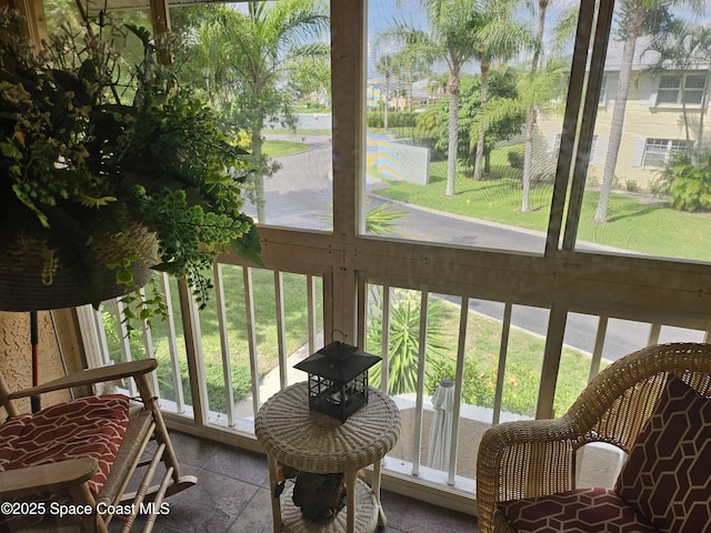 997 Sonesta Ave NE Unit 202, Palm Bay, FL 32905 - sunroom with stone tile floors and healthy amount of natural light