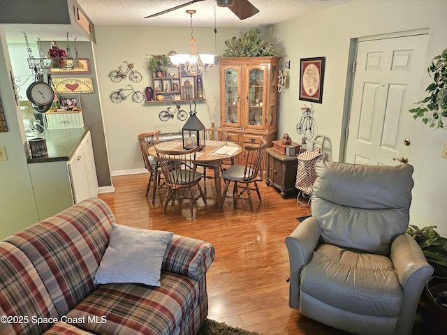 997 Sonesta Ave NE Unit 202, Palm Bay, FL 32905 - living area featuring light wood finished floors, a chandelier, and a ceiling fan
