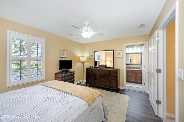 2550 Revolution St Unit 103, Melbourne, FL 32935 - bedroom featuring dark wood-style floors, a ceiling fan, and connected bathroom