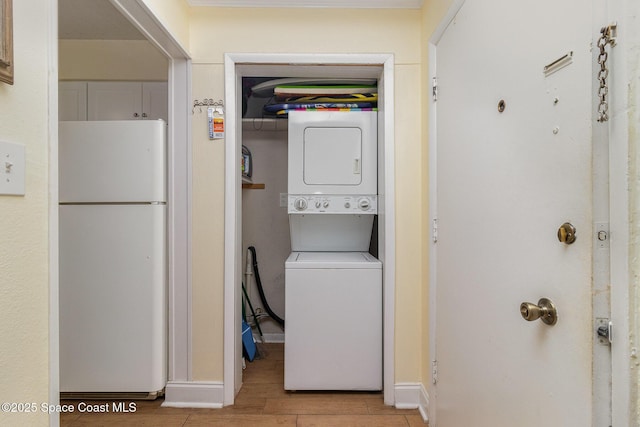 3150 N Atlantic Ave Unit 7-440, Cocoa Beach, FL 32931 - laundry area featuring stacked washer / dryer and light wood-type flooring