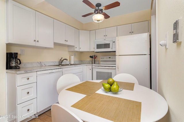 3150 N Atlantic Ave Unit 7-440, Cocoa Beach, FL 32931 - kitchen with white appliances, ceiling fan, white cabinetry, and light countertops