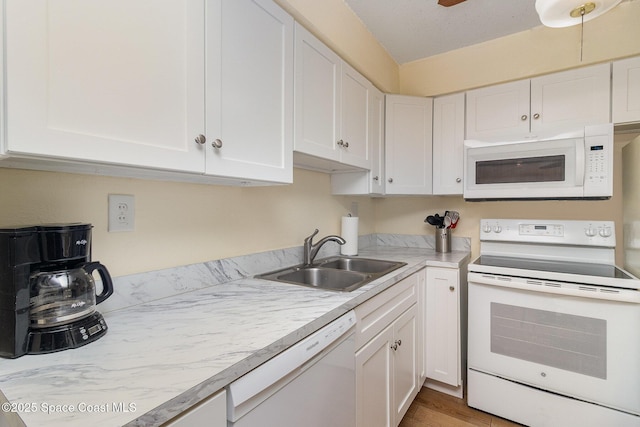 3150 N Atlantic Ave Unit 7-440, Cocoa Beach, FL 32931 - kitchen featuring white appliances, white cabinetry, and light countertops