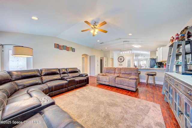 4082 Brantley Cir, Rockledge, FL 32955 - living room with lofted ceiling, dark wood-type flooring, ceiling fan, and arched walkways