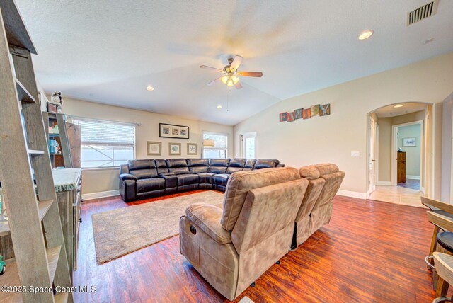 4082 Brantley Cir, Rockledge, FL 32955 - living area featuring arched walkways, ceiling fan, wood finished floors, lofted ceiling, and recessed lighting