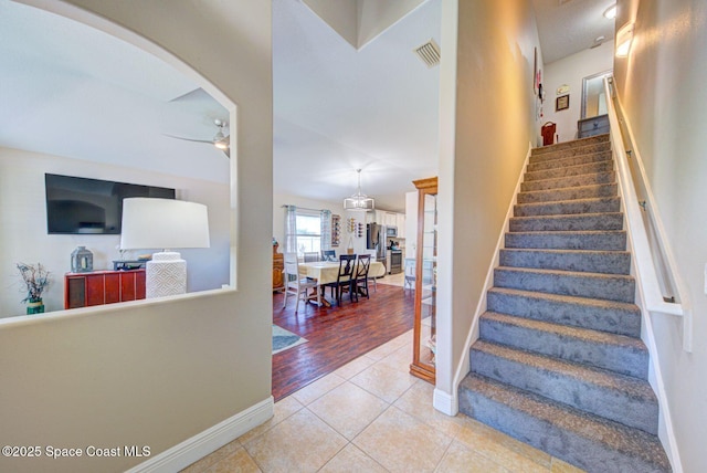 4082 Brantley Cir, Rockledge, FL 32955 - stairway featuring a ceiling fan, tile patterned floors, and arched walkways