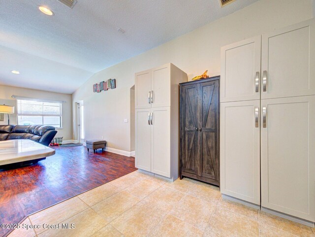 4082 Brantley Cir, Rockledge, FL 32955 - living area featuring vaulted ceiling, light tile patterned floors, recessed lighting, and a textured ceiling
