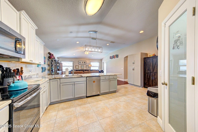 4082 Brantley Cir, Rockledge, FL 32955 - kitchen featuring stainless steel appliances, a peninsula, hanging light fixtures, open floor plan, and light tile patterned floors