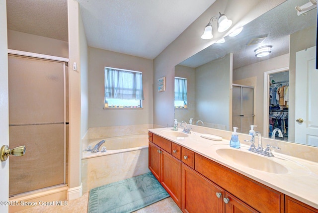 4082 Brantley Cir, Rockledge, FL 32955 - bathroom with a shower stall, a garden tub, double vanity, a spacious closet, and tile patterned floors
