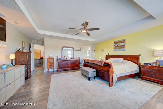 4082 Brantley Cir, Rockledge, FL 32955 - bedroom featuring a tray ceiling, wood finished floors, and ceiling fan