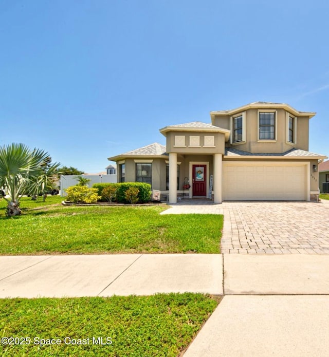 4082 Brantley Cir, Rockledge, FL 32955 - view of front of property featuring decorative driveway, stucco siding, a garage, and a front yard