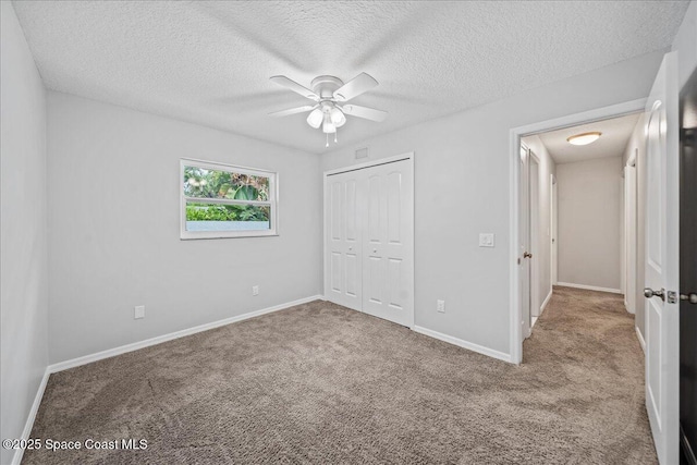 380 Cherry Ct, Satellite Beach, FL 32937 - unfurnished bedroom with carpet, a textured ceiling, a closet, and ceiling fan