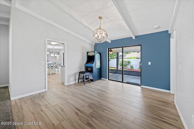 380 Cherry Ct, Satellite Beach, FL 32937 - unfurnished room with a chandelier and wood finished floors