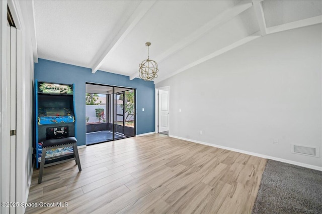 380 Cherry Ct, Satellite Beach, FL 32937 - unfurnished living room with a chandelier and light wood finished floors