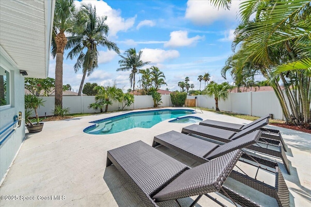 380 Cherry Ct, Satellite Beach, FL 32937 - view of swimming pool featuring a patio area, a pool with connected hot tub, and a fenced backyard