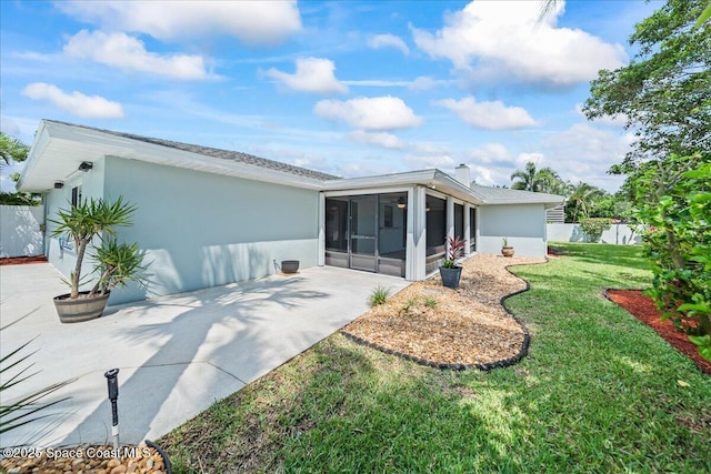 380 Cherry Ct, Satellite Beach, FL 32937 - back of property with a sunroom, stucco siding, and a patio area