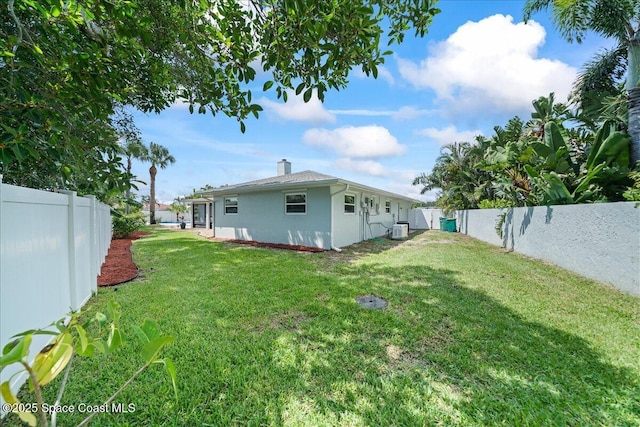 380 Cherry Ct, Satellite Beach, FL 32937 - rear view of property with a fenced backyard, a chimney, and stucco siding