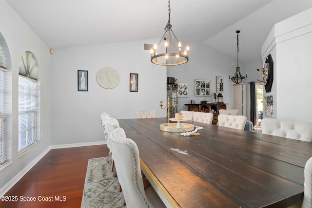 1276 Cypress Trace Dr, Melbourne, FL 32940 - dining room featuring a chandelier, wood finished floors, and vaulted ceiling