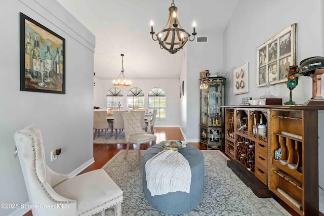 1276 Cypress Trace Dr, Melbourne, FL 32940 - living area with a chandelier, wood finished floors, and lofted ceiling