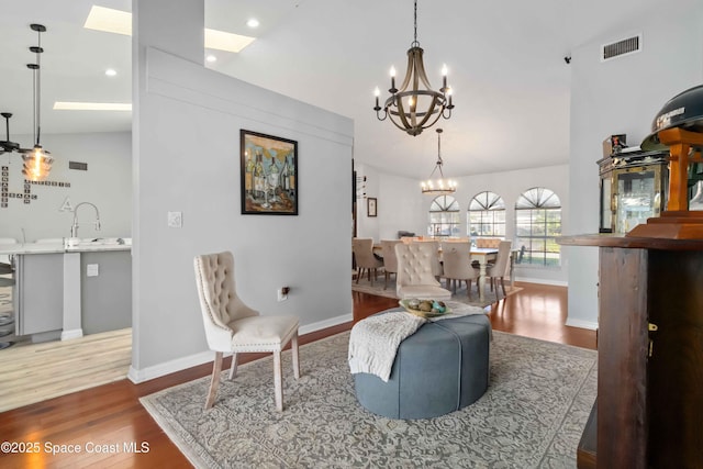 1276 Cypress Trace Dr, Melbourne, FL 32940 - living area with vaulted ceiling, a chandelier, wood finished floors, and recessed lighting