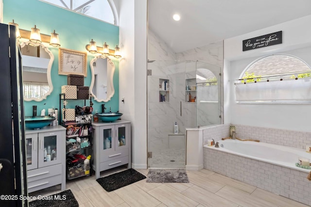 1276 Cypress Trace Dr, Melbourne, FL 32940 - full bathroom featuring healthy amount of natural light, a bath, a marble finish shower, vanity, and vaulted ceiling
