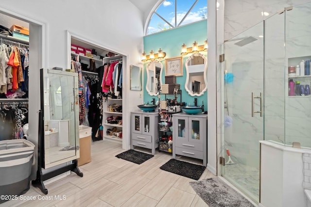1276 Cypress Trace Dr, Melbourne, FL 32940 - bathroom featuring vanity, a marble finish shower, and a spacious closet