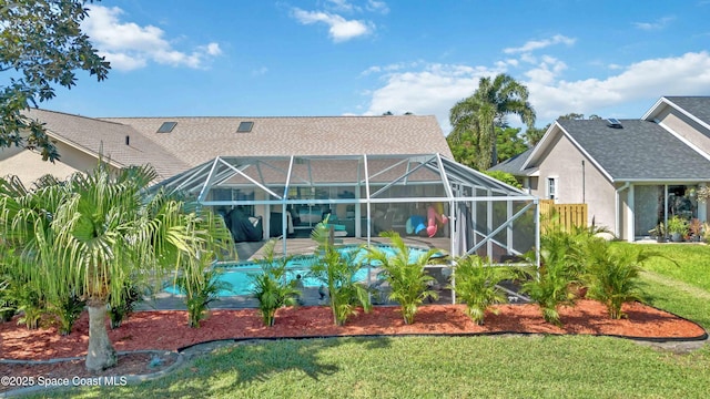 1276 Cypress Trace Dr, Melbourne, FL 32940 - back of property featuring a yard, an outdoor pool, glass enclosure, stucco siding, and a patio