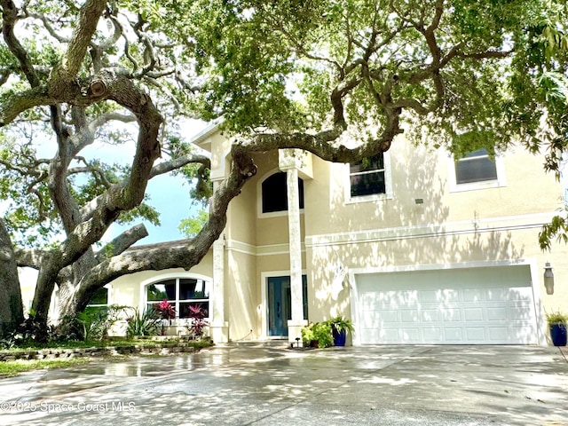 52 Riverview Ln, Cocoa Beach, FL 32931 - view of front facade with concrete driveway, stucco siding, and a garage