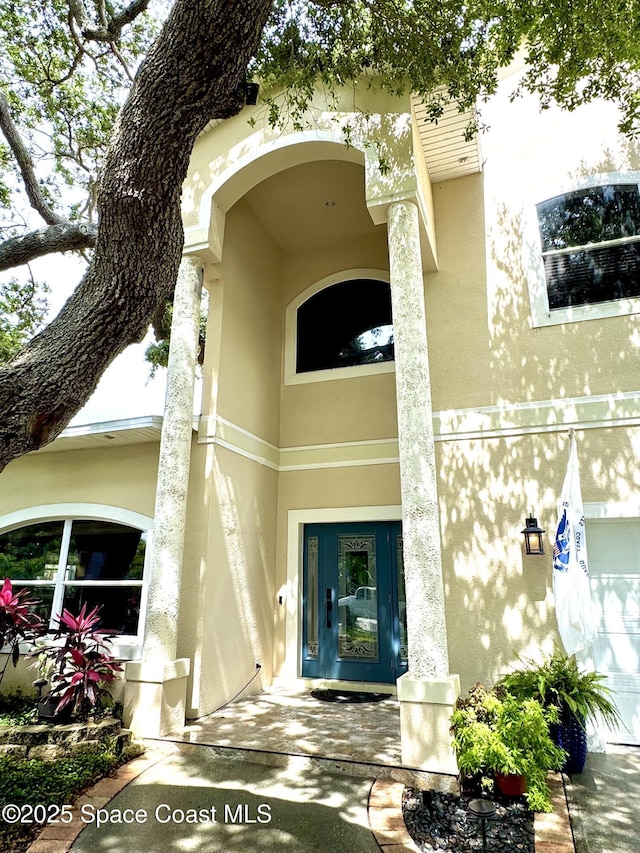 52 Riverview Ln, Cocoa Beach, FL 32931 - doorway to property featuring stucco siding