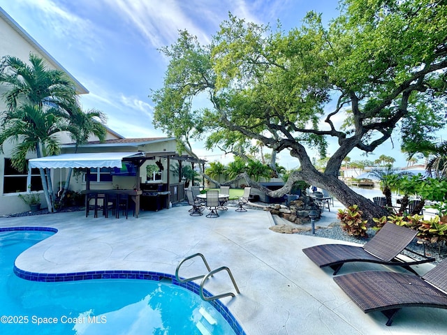 52 Riverview Ln, Cocoa Beach, FL 32931 - swimming pool with outdoor dining space and a patio area